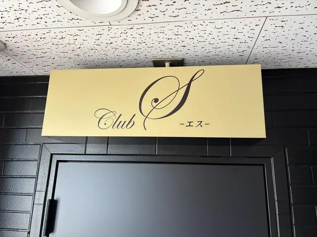 淡い黄色の「Club S」入口看板
