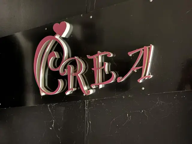 黒壁に赤い立体文字の「CRE.A」看板